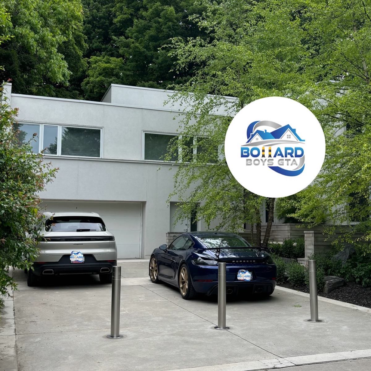 Automatic bollards on a modern home driveway with two Porsches